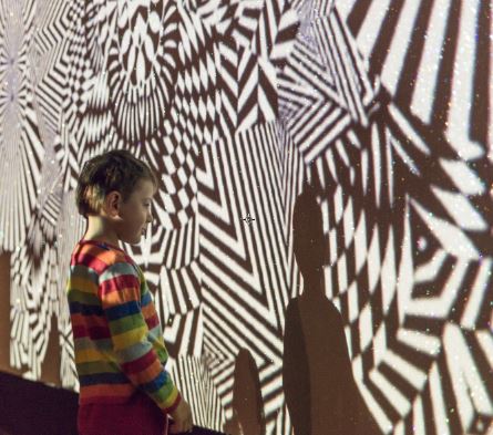 A boy views one of the art works in Wheriko - Brilliant! exhibition.