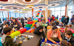 children play with lego in a large room